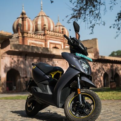 Photo by Ather Energy a motorcycle parked in front of a building
